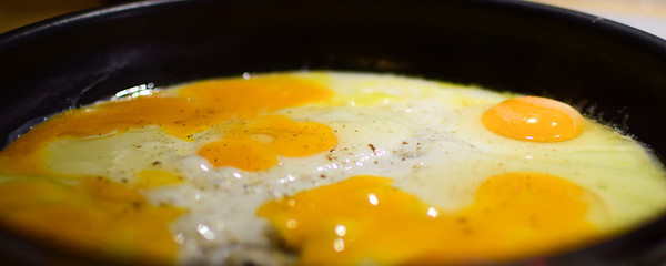 Fried eggs in a pan. Cooking process.