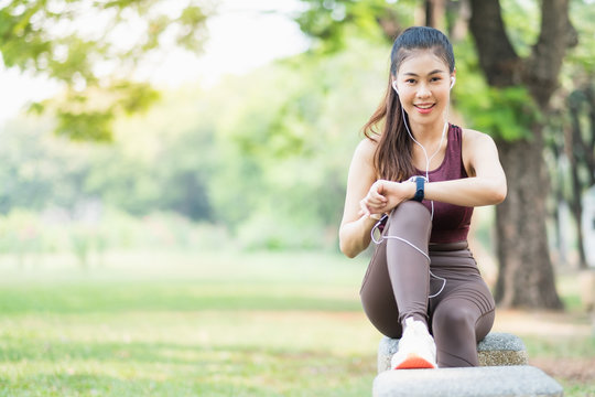 Young beautiful Asian girl run To exercise In the park City center sunlight good weather Stretch relax On vacation In the morning bright Health care