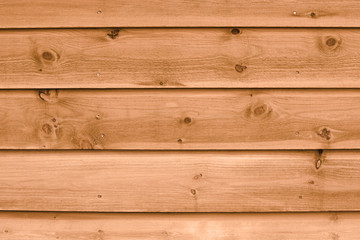 Texture of a fragment of a wooden house wall. The wall is painted natural color