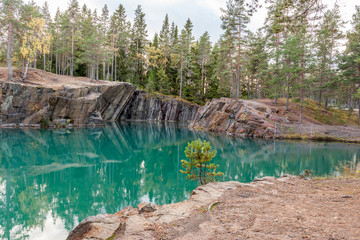 Old abandoned silver mine with blue, emerald water on a sunny evening. silverberg in Sweden. selective focus