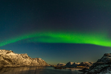 Naklejka na ściany i meble unforgettable aurora borealis, northern lights, over mountains in the North of Europe - Lofoten islands, Norway