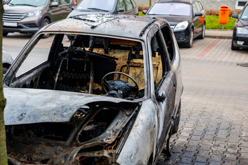 Fototapeta na wymiar Closeup of the car burnt down on the city car park