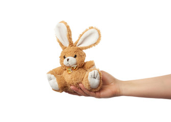 female hand holds a small brown rabbit toy
