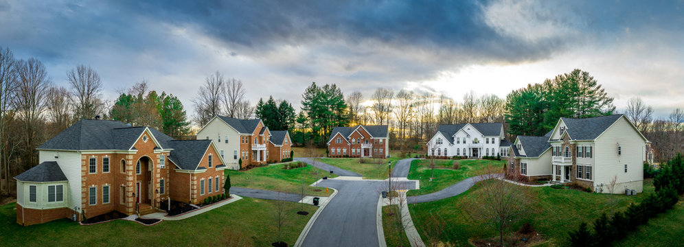 American Luxury Cul-de-sac Neighborhood Street Landscaped Single Family Mansions W/ Curb Appeal, Large Houses W/ Stone, Brick  Vinyl Facade, Quoin Corners, Elegant White Portico Entrances Dramatic Sky