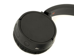 part of the black wireless headphones isolated against a white background