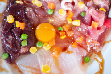 Fresh raw meal with eggs in dish ready for cooking