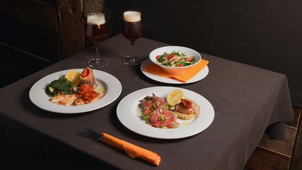 Dinner with a beer. Salad, seafood, meat.   