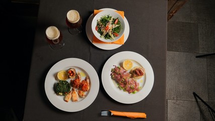 Dinner with a beer. Salad, seafood, meat.   