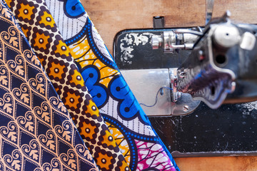 Sewing machine and African fabrics in seamstress workshop, Mozambique