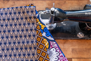 Sewing machine and African fabrics in seamstress workshop, Mozambique