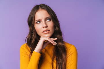 Image of young beautiful woman thinking and looking at copyspace