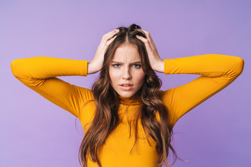 Image of young displeased woman being nervous and grabbing her head