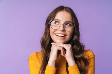 Image of young woman wearing eyeglasses smiling and looking upward