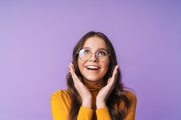 Image of young woman wearing eyeglasses smiling and looking upward