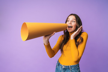 Image of young beautiful woman smiling and speaking on paper bullhorn