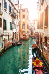 Scenic canal with gondolas in Venice, Italy. Famous travel destination