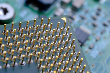 old computer processor with gold-plated legs, microcircuits on it, super macro photo