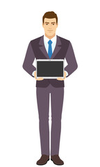 Smiling Businessman showing blank digital tablet PC. Full length portrait of Businessman in a flat style.