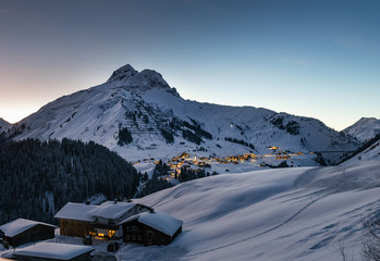 The Austrian ski resort Warth in winter at dusk in the snowy Alps.