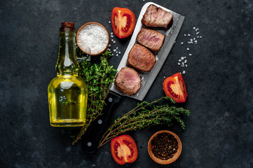 Grilled beef steak over meat knife with spices. View from above. on a stone background. with copy space for your text
