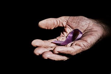 senior woman with a purple ribbon in her hand