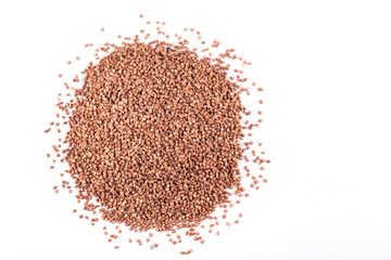 heap of buckwheat scattered on a white background