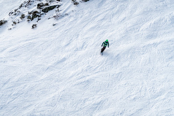 Freeride snowboarder going downhill. Aerial view.