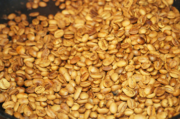 Coffee beans roasted to golden and brown are on the counter in the store