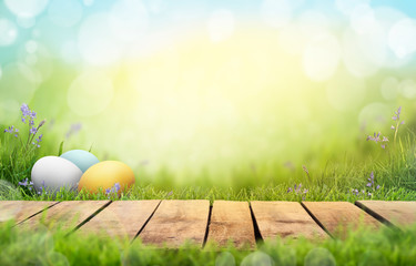 A wooden product display top with an Easter background of painted eggs and green grass and meadows. - Powered by Adobe