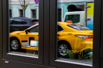 Fototapeta na wymiar Reflection in the glass of a taxi car