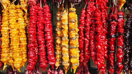 Churchkhela candies hanging in front of market stall in Tbilisi, Georgia. Churchkhela is a traditional Georgian cuisine candle-shaped candy