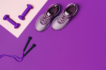 Sports equipment for women's training. Pink-purple background, diagonal composition.