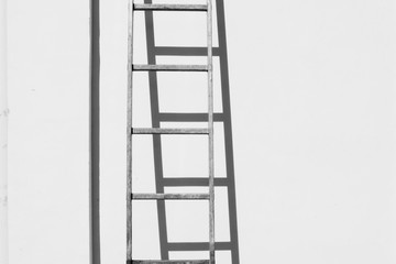 Alumunium ladder on white wall background