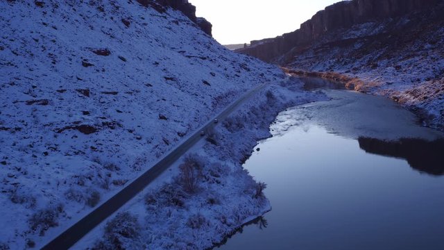 Aerial Footage of Colorado River in Winter Near Moab, Utah U.S.A. Following Cars Flyover Drone Footage
