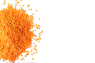 orange lentil beans in a heap on a white background