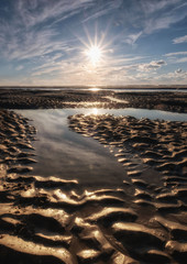 Tranquil colorful sunset over sea, viewed from the dutch coast. The Netherlands