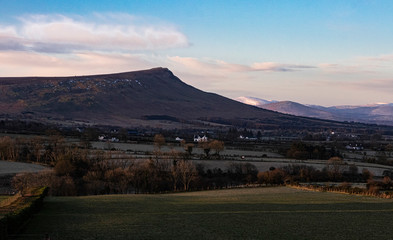 Benbradagh Mountain with snow capped mountains behind it just after Dawn, The High Sperrins, County Londonderry, Northern Ireland
