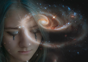 A young girl with a burning star on her forehead and downcast eyes against the starry sky. The concept of clairvoyance, mysticism, divination, divination. Elements of this image are provided by NASA.