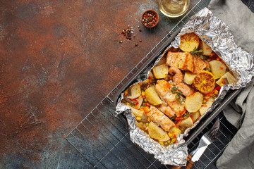 Foil pack dinners. Salmon with vegetables baked in foil. Dietary food. Top view