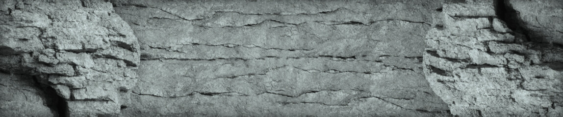 Gray stone background. Vintage rock texture. The texture of a weathered mountain is similar to an old ancient wall. Grunge gray background with copy space for your design.
