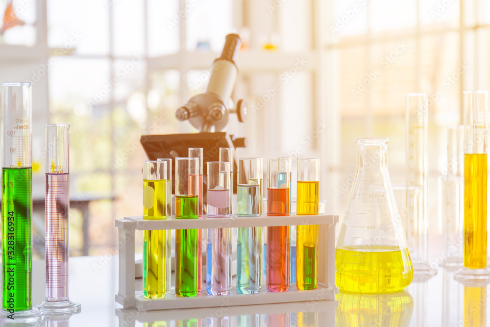 Aufkleber chemical reagent in scientific experiment flasks of various shapes, sizes and with orange light.