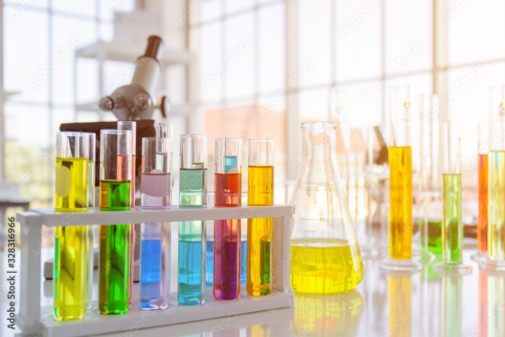 Poster Chemical reagent bottles, scientific experiment bottles of various shapes, sizes and microscopes on the table