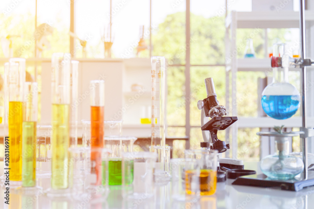 Poster Chemical reagent bottles, scientific experiment bottles of various shapes, sizes and microscopes on the table