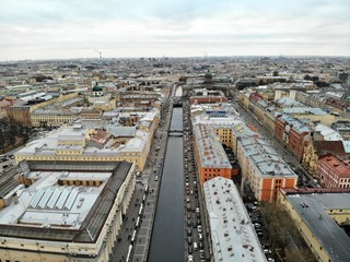Fototapeta premium Aerial view of Griboyedov Canal and Kazan Cathedral with high traffic at winter. different roofs of citycenter of Saint-Petersburg cityscape 