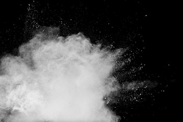 White talcume powder explosion on black background. White dust particles splash.