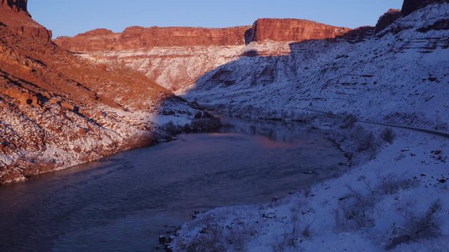 Aerial Footage Flyover of Colorado River in Winter with Reflections Near Moab, Utah U.S.A. Following Cars Below by Drone