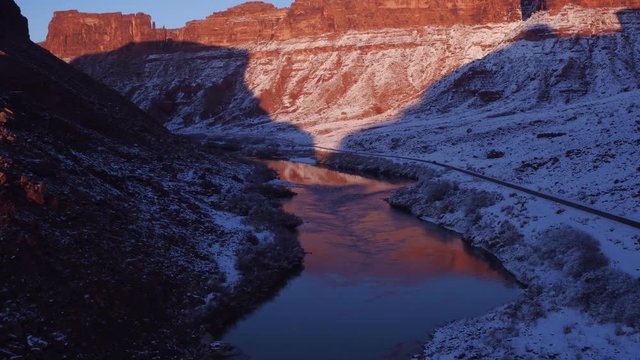 Aerial Footage Flyover of Colorado River and Refelctions in Winter Near Moab, Utah U.S.A. Following Cars by Drone & Reflection