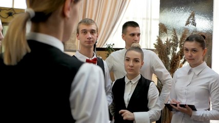 Briefing at the restaurant. Interacting to head manager in commercial hall