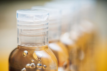 A row of hand cleaning gel bottles, fading to a blur. Health & safety.