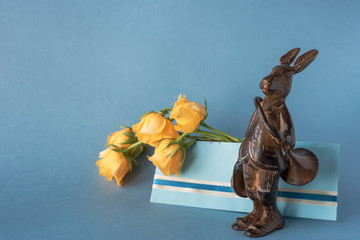 Copper hare-postman with postal horn and envelope with yellow roses